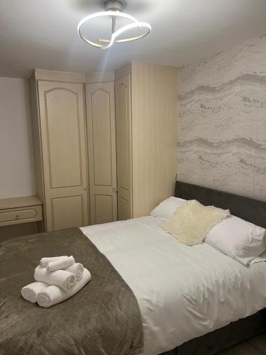 a bedroom with a bed with two towels on it at Pats Place in Liverpool