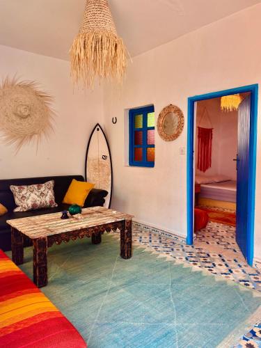 a living room with a couch and a table at Global Surf GuestHouse in Sidi Kaouki