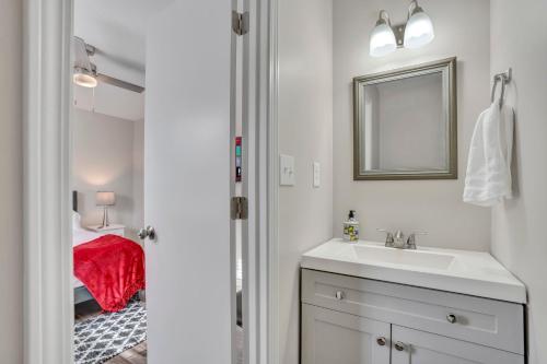 a bathroom with a sink and a mirror and a bed at Red Ranch Bring Your Dogs! Fenced Yard in Clarksville