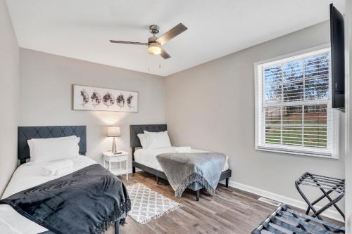 a bedroom with two beds and a window at Red Ranch Bring Your Dogs! Fenced Yard in Clarksville