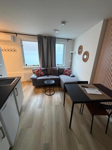 a living room with a couch and a table at Apartement hotel Stays by ADM in Leiden