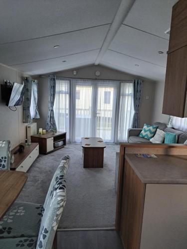 a large living room with a couch and a table at The vintage in Winthorpe