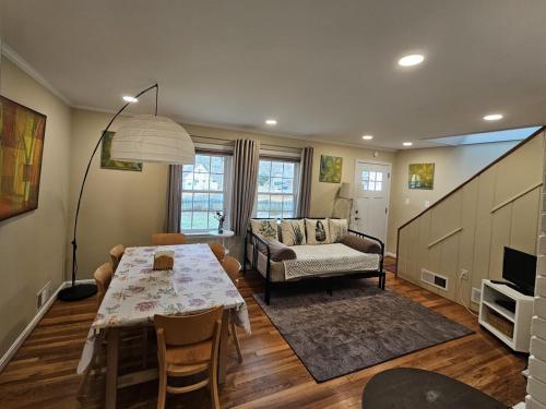a living room with a table and a couch at Park House Mada in Rockville