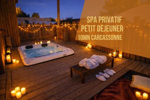 a hot tub with candles on a deck with lights at Les Gîtes de Laure - L'Eden Romantique, B&B, Spa privatif et Petit Déjeuner, Couloir de nage, 10mn Carcassonne in Malves-en-Minervois