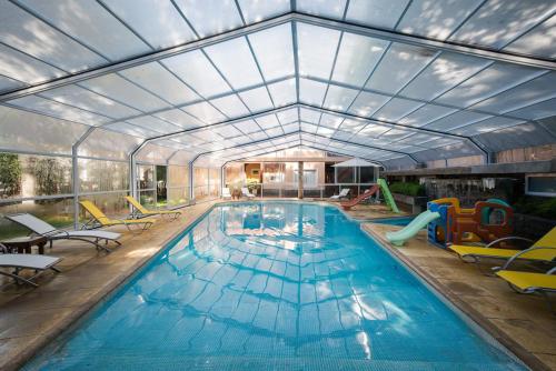 a large swimming pool with a large ceiling at Carilo Princess in Carilo