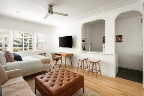 a living room with a bed and a table at Beverly Grove Hotel in Los Angeles