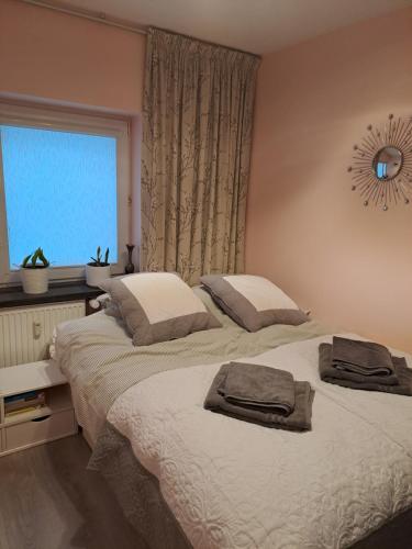 a bedroom with two beds with towels on them at Silver Apartament Kowary in Kowary