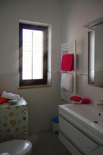 a bathroom with a sink and a mirror at Il Cortiletto in Castelbuono