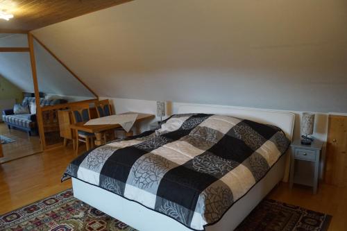 a bedroom with a bed and a living room at Ferienhaus Am Arzberg in Kurort Steinbach-Hallenberg