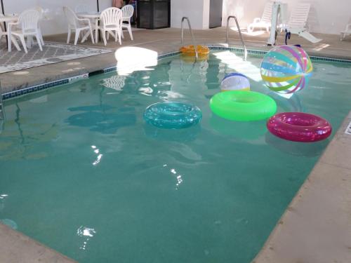 a pool with four frisbees in the water at Country Inn & Suites by Radisson, Cedar Rapids Airport, IA in Cedar Rapids