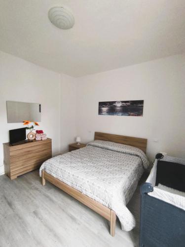 a bedroom with a bed and two night stands in it at La Casina di Orsolina - Check-in Flessibile in Livorno