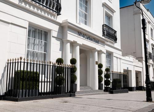 a white building with a fence in front of it at No.4 Carlton in Southampton