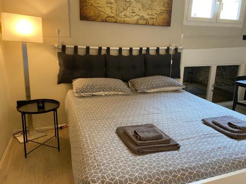 a bedroom with a large bed with a black headboard at La Perla del Centro in Bologna