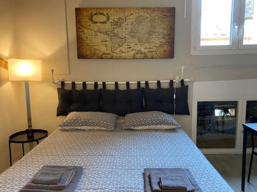 a bedroom with a bed with two towels on it at La Perla del Centro in Bologna