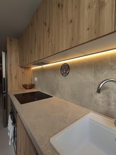 a kitchen with a sink and a counter top at La Llar de la Font in Barraca de Aguas Vivas