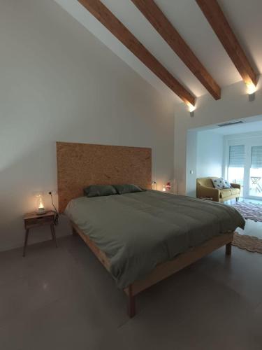 a bedroom with a large bed in a room at La Llar de la Font in Barraca de Aguas Vivas