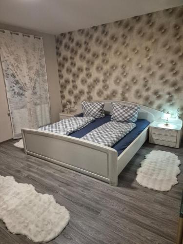 a bedroom with a bed with blue and white pillows at Inna's and Dima's Ferienwohnung in Pirmasens