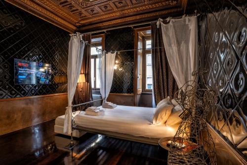 a bedroom with a bed with a canopy at Ilsanleonardo in Bergamo
