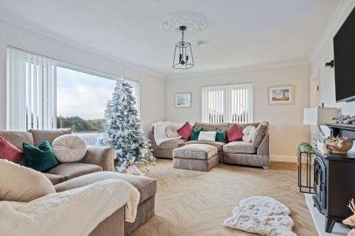 a living room with a christmas tree in it at Church View Country House