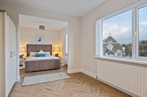 a bedroom with a bed and a large window at Church View Country House