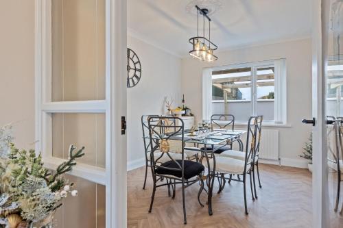 a dining room with a table and chairs at Church View Country House