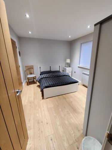 a bedroom with a bed and a wooden floor at Durham Norwood detached Bungalow in Trimdon Grange