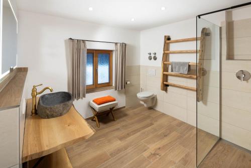 a bathroom with a shower and a sink and a toilet at Rauchenbichlhof in Ruhpolding