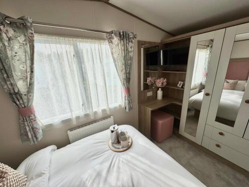 a bedroom with a white bed and a mirror at The Lobster Pot in Ilfracombe