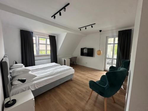 En eller flere senge i et værelse på Pensjonat Kapitan