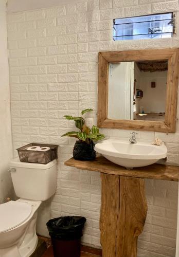 a bathroom with a sink and a toilet and a mirror at Casa Costa Sirena in El Gigante