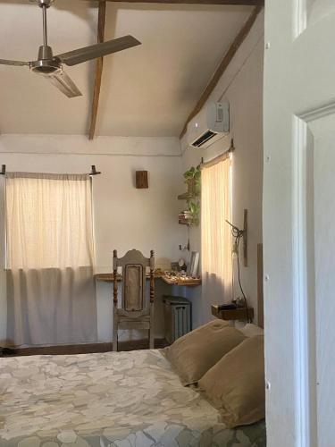 a bedroom with a bed and a table and a window at Casa Costa Sirena in El Gigante