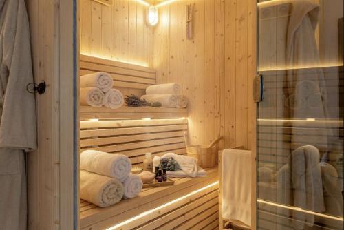 a bathroom with a bunch of towels in a room at Alghero Villa Flamingo Luxury Resort with exclusive pool, gym and SPA in Alghero