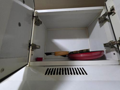 a knife and a red bowl in a box at Ajman Luxury Downtown B9OO7 in Ajman 
