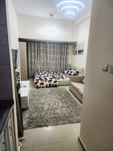 a living room with a bed and a couch at Ajman Luxury Downtown B9OO7 in Ajman 