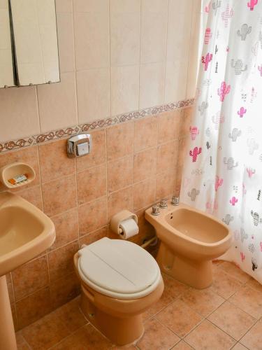 a bathroom with a toilet and a sink at Depto 1 in Villa Carlos Paz