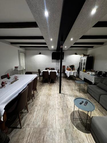 a room with a long table and chairs and a couch at View Racha in Ambrolauri