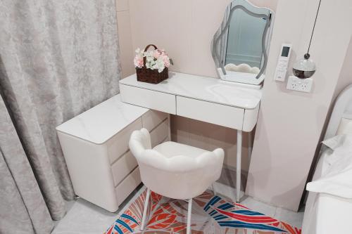 a white bathroom with a white vanity and a white chair at Nadi Ease Stay Near McDonalds in Nadi
