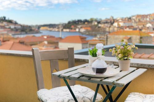a table on a balcony with a view of a city at MyRiverPlace N 4 Private Terrace River View Porto apartments in Vila Nova de Gaia