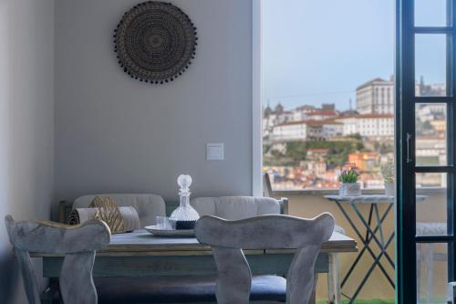 a dining room with a table and two chairs at MyRiverPlace N 4 Private Terrace River View Porto apartments in Vila Nova de Gaia