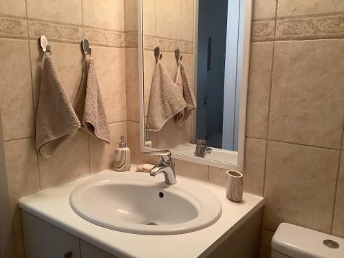 a bathroom with a sink and a mirror and a toilet at Urban Nest - near GSP & General Hospital in Laxia