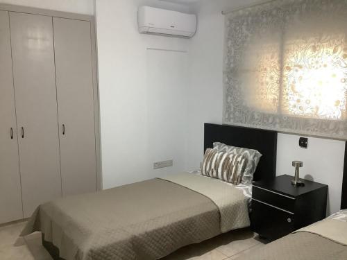 a bedroom with two beds and a window at Urban Nest - near GSP & General Hospital in Laxia