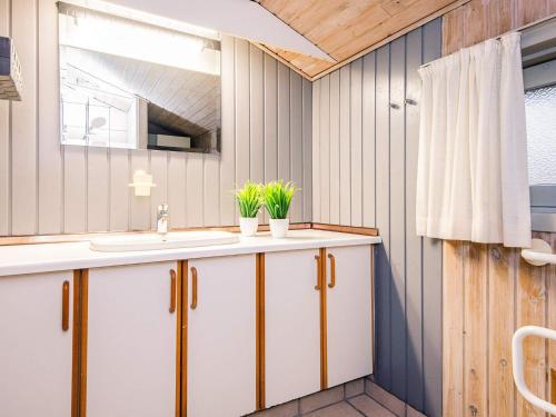 a bathroom with a sink and a mirror at Luxury Retreat near Kvie So - By Traum Ferienwohnungen in Ansager