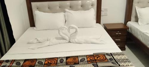two towels in the shape of hearts on a bed at Ocean & Beach kite Hotel in Kalpitiya