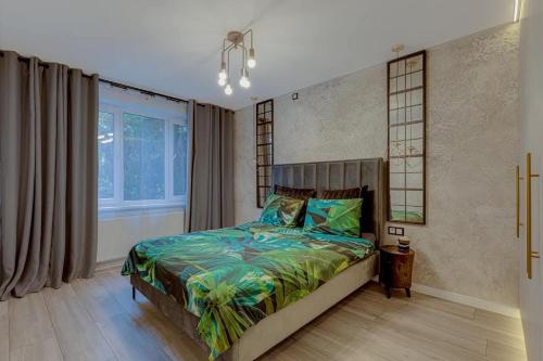 a bedroom with a large bed in a room at LOCUSDO Apartment No.31 in Mažeikiai