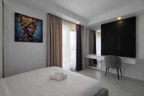 a bedroom with a bed with two towels on it at Nova Studio Bucharest #pool&parking in Ştefăneştii de Sus