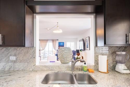 a kitchen counter top with a sink and a kitchen at Playa Blanca Condo in Tijuana