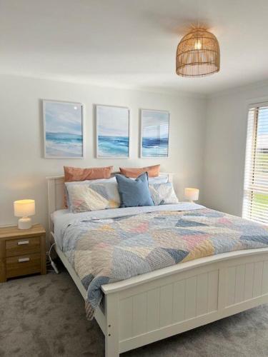 a bedroom with a bed with pillows on it at Coastal Calm in Normanville