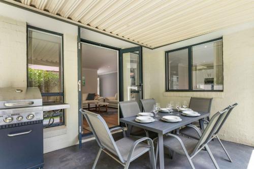 a dining room with a table and chairs at White Sands Villa by Experience Jervis Bay in Huskisson