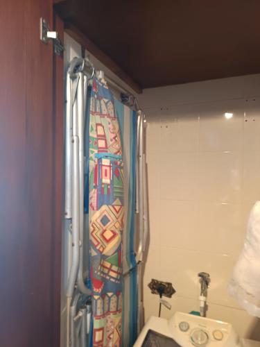 a shower curtain in a bathroom with a sink at Apto completo,1 dorm, pé na areia na Cidade Praia Grande, praia mirim in Praia Grande