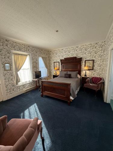 a large bedroom with a bed and a couch at Shaw House Inn in Ferndale